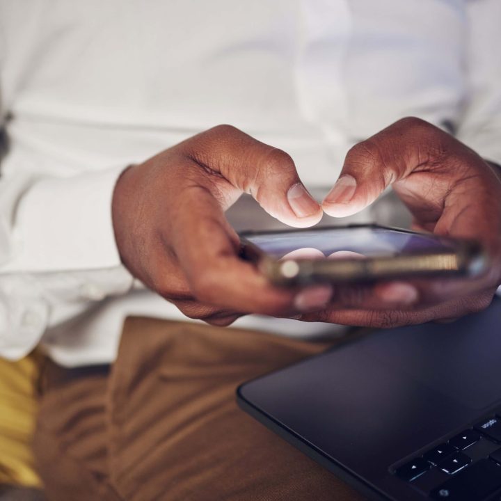 laptop-online-and-hands-of-person-with-phone-for-2023-11-27-05-15-34-utc (1) (1)